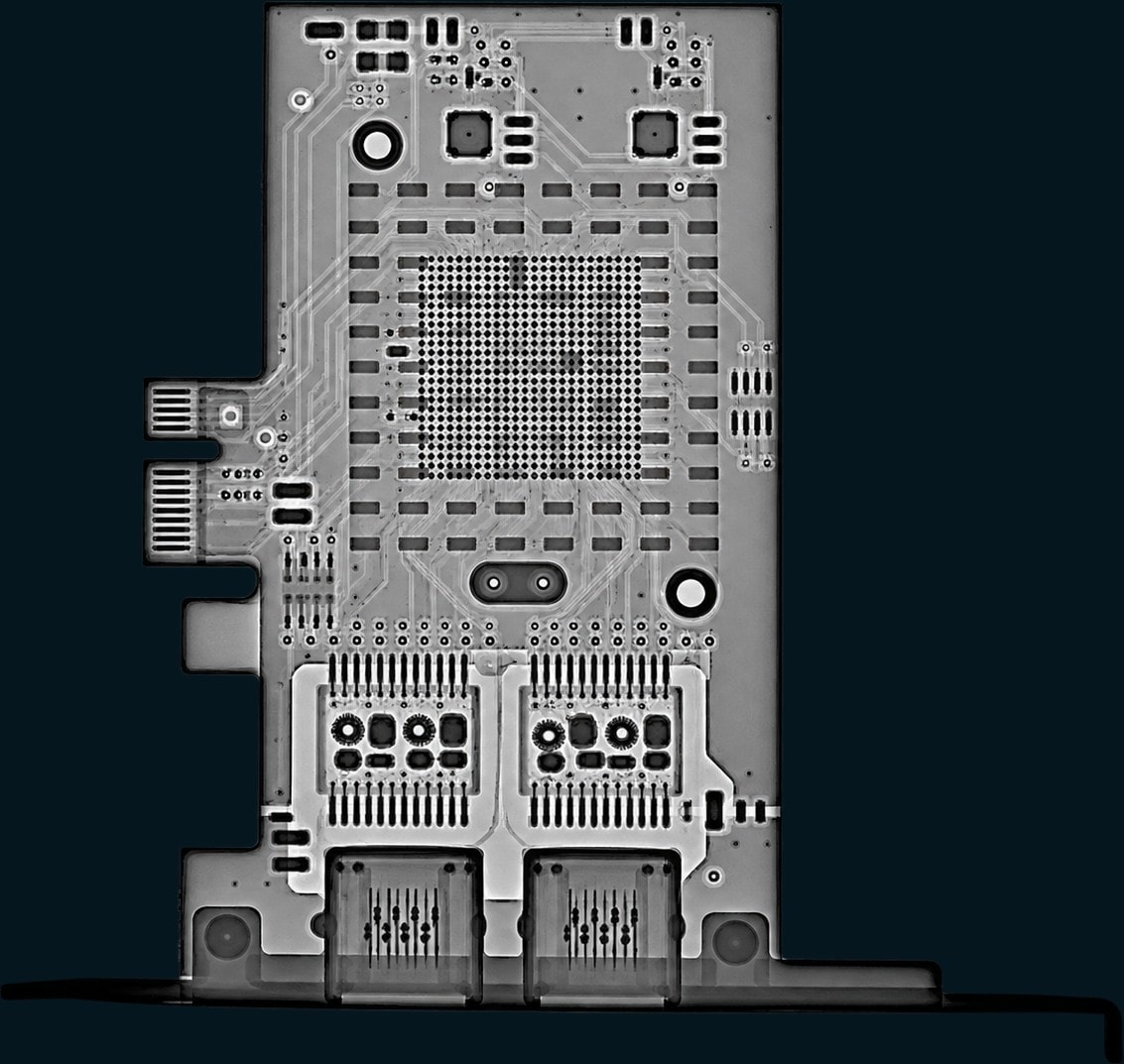 X-ray of an assembled card showing a BGA array, magnetics and two connectors