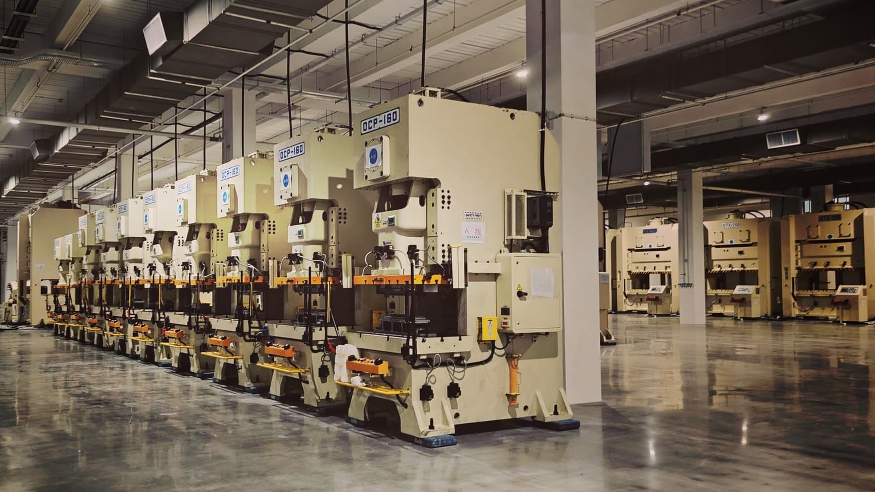 Production floor lined with inspection and manufacturing machinery